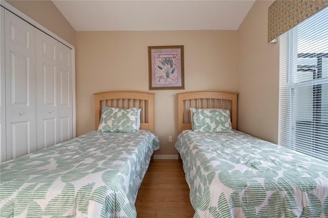 bedroom featuring wood-type flooring and a closet