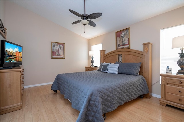 bedroom featuring light hardwood / wood-style flooring, vaulted ceiling, and ceiling fan