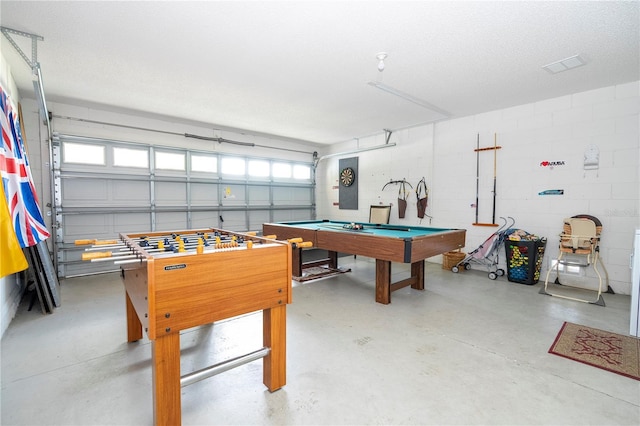 recreation room featuring a textured ceiling