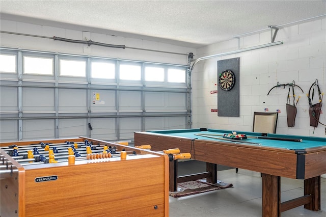 playroom with a textured ceiling and billiards