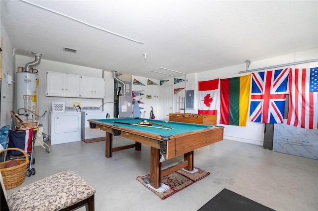 playroom featuring water heater, separate washer and dryer, electric panel, and a textured ceiling