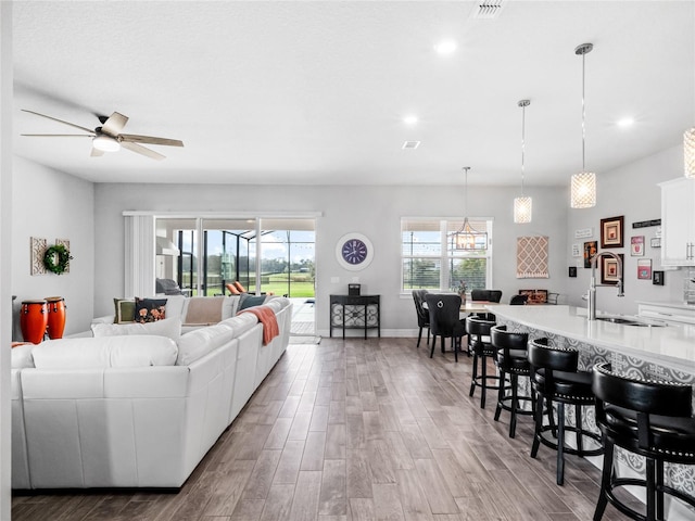 living room featuring recessed lighting, visible vents, ceiling fan, and wood finished floors