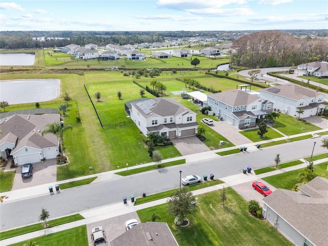 drone / aerial view featuring a water view and a residential view