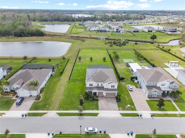 drone / aerial view with a water view and a residential view