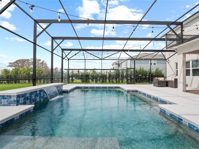 outdoor pool with glass enclosure and a patio area