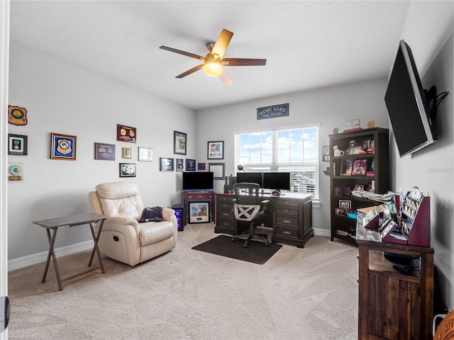 office with baseboards, a ceiling fan, and light colored carpet