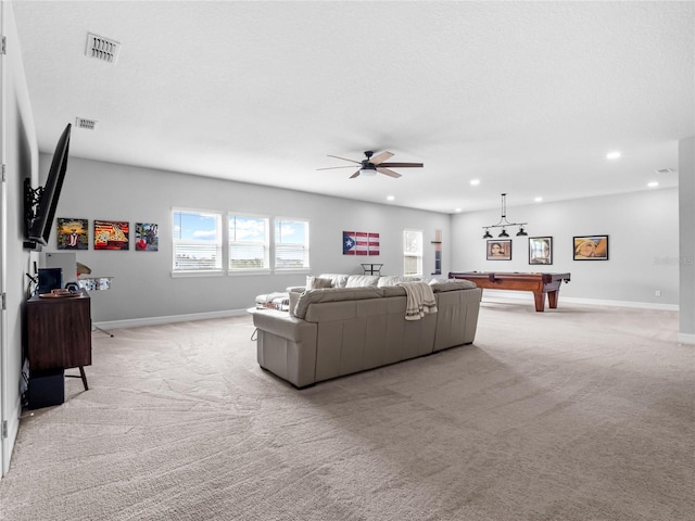 living area featuring baseboards, recessed lighting, visible vents, and light colored carpet