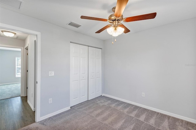 unfurnished bedroom with light carpet, baseboards, visible vents, and a closet