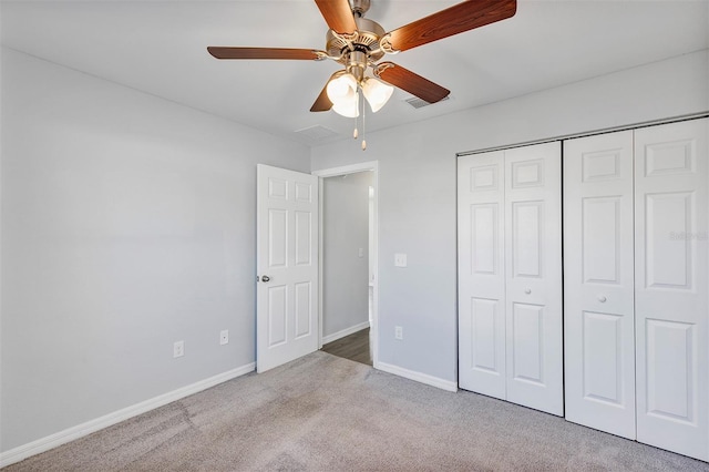 unfurnished bedroom featuring visible vents, baseboards, a closet, and light colored carpet