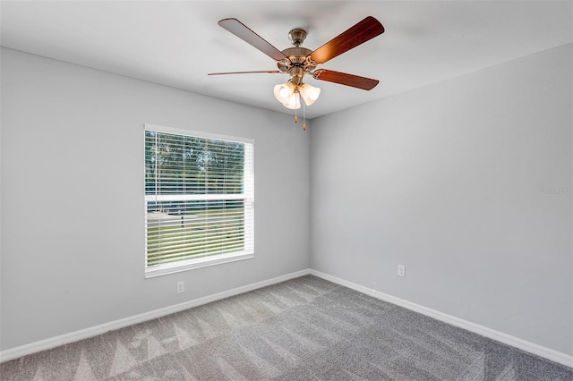 empty room featuring carpet, baseboards, and ceiling fan