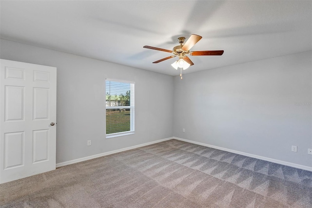 empty room featuring carpet floors, ceiling fan, and baseboards