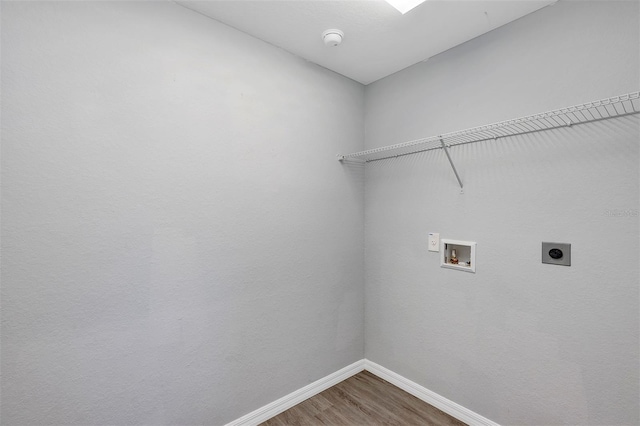 laundry room with washer hookup, electric dryer hookup, wood finished floors, laundry area, and baseboards