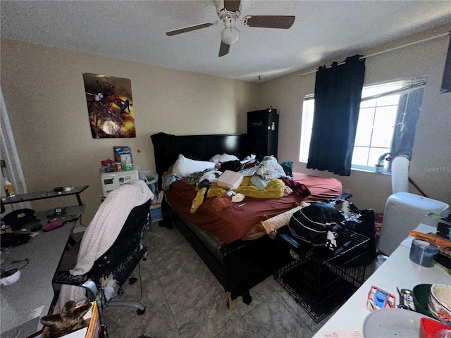 bedroom featuring a textured ceiling and ceiling fan