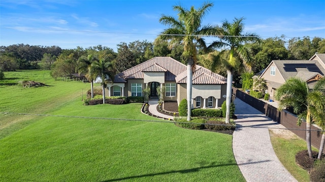 mediterranean / spanish home with a front yard