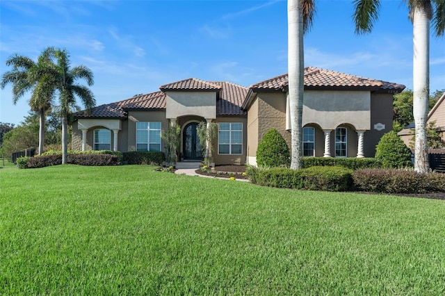 mediterranean / spanish home featuring a front yard