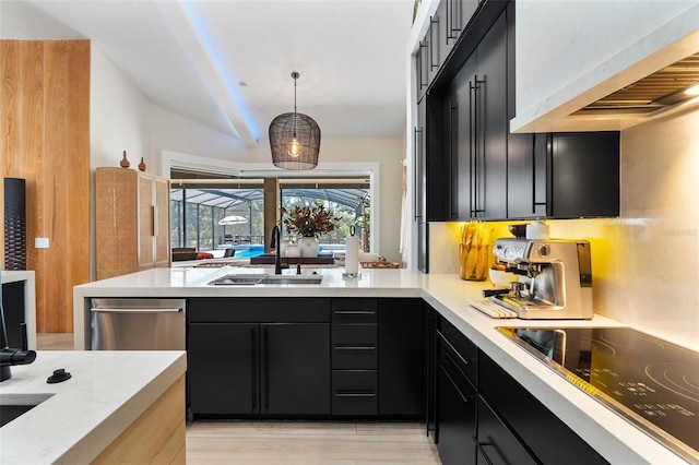 kitchen featuring hanging light fixtures, sink, black electric cooktop, and wall chimney exhaust hood