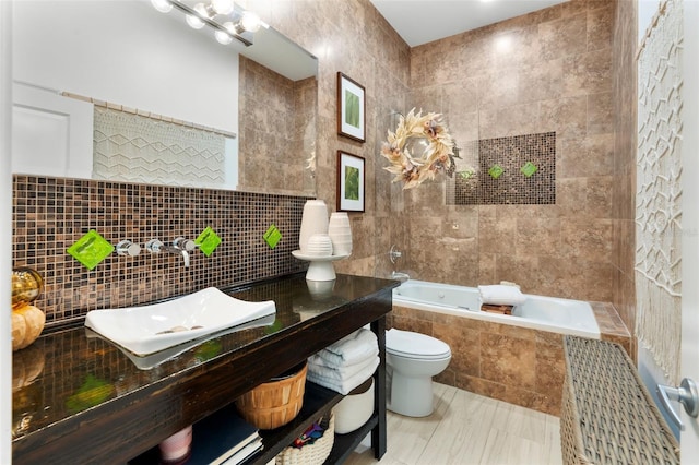 bathroom with tile walls, a relaxing tiled tub, and toilet