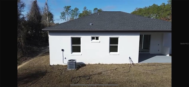 rear view of house featuring cooling unit