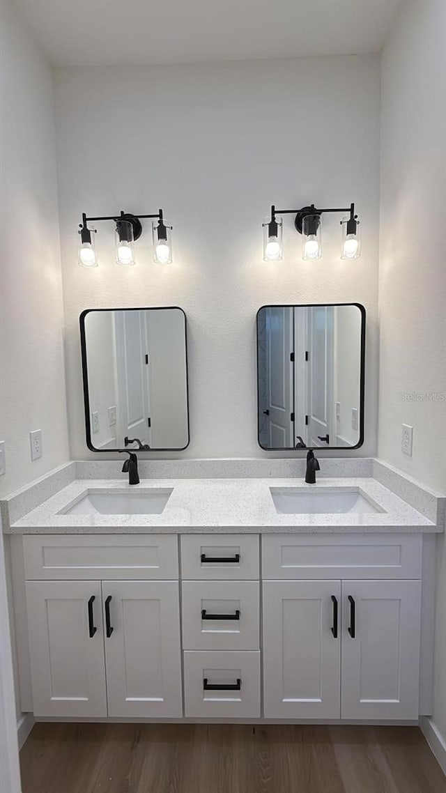 bathroom with vanity and hardwood / wood-style floors