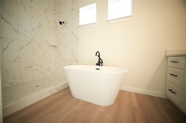 bathroom with shower with separate bathtub, hardwood / wood-style floors, and vanity