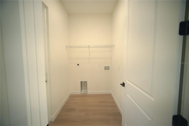 laundry area with electric dryer hookup, washer hookup, and light hardwood / wood-style floors