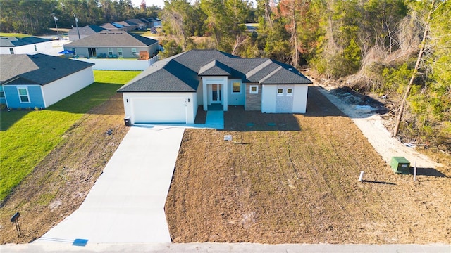 view of front facade featuring a garage and a front lawn