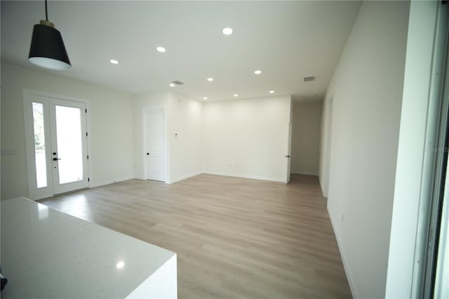 interior space with light hardwood / wood-style floors and french doors