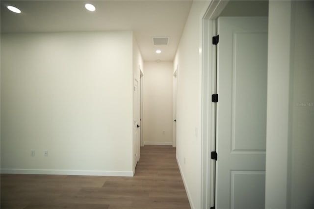 hallway with hardwood / wood-style flooring