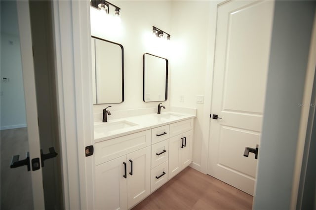 bathroom with vanity and wood-type flooring