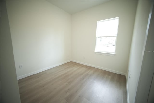 empty room with light hardwood / wood-style flooring