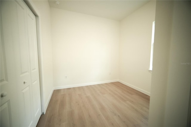 unfurnished bedroom with a closet and light hardwood / wood-style flooring