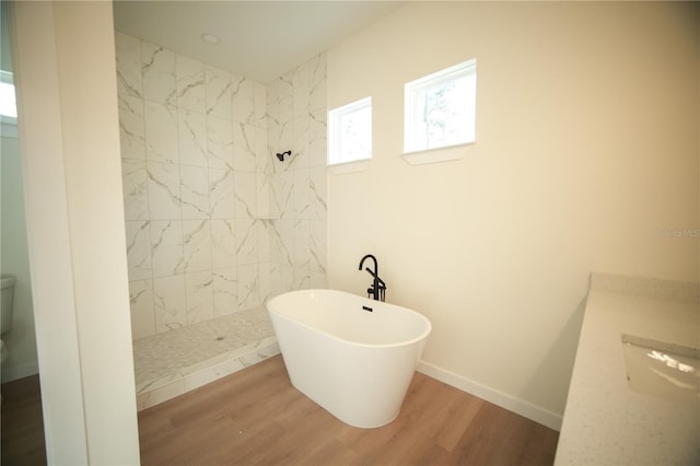 bathroom with vanity, hardwood / wood-style flooring, and separate shower and tub