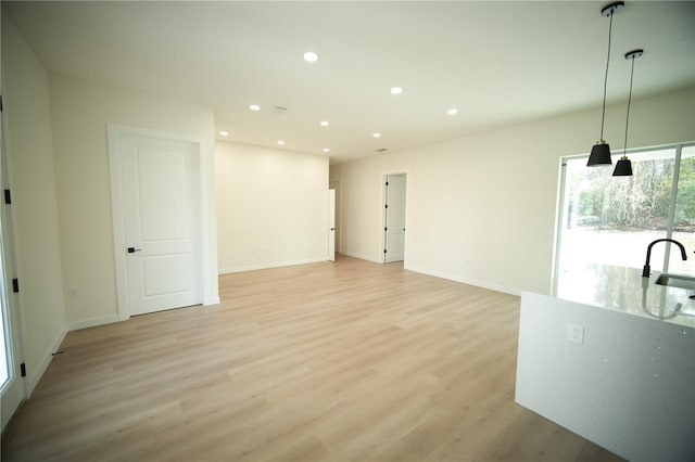 interior space featuring sink and light hardwood / wood-style floors