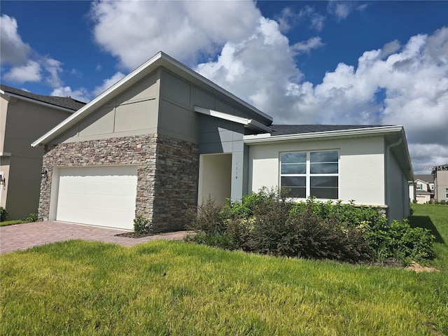 modern home featuring a garage and a front lawn