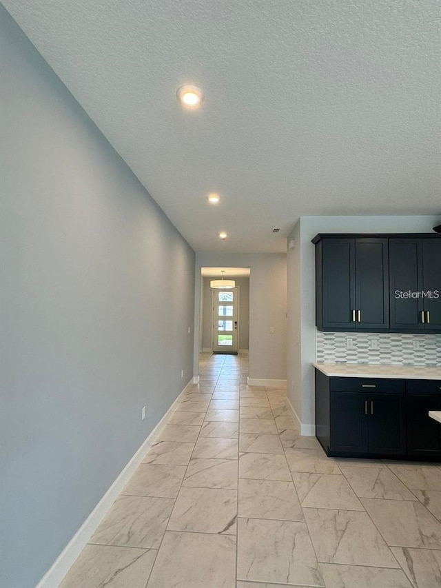 corridor featuring a textured ceiling