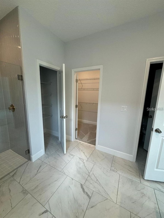 bathroom featuring a shower with door