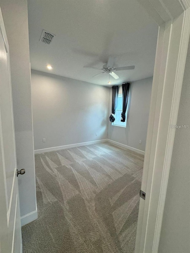 unfurnished room featuring carpet and ceiling fan