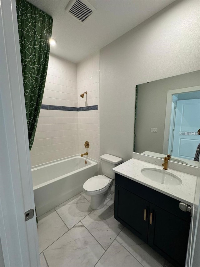 full bathroom featuring tiled shower / bath, vanity, and toilet