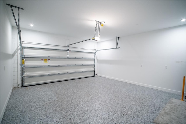 garage featuring a garage door opener, recessed lighting, and baseboards