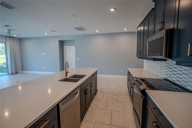 kitchen with visible vents, stainless steel appliances, a sink, and light countertops