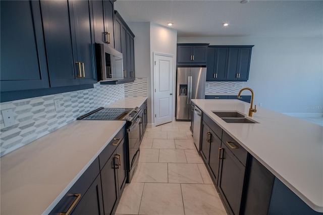 kitchen featuring marble finish floor, tasteful backsplash, light countertops, appliances with stainless steel finishes, and a sink