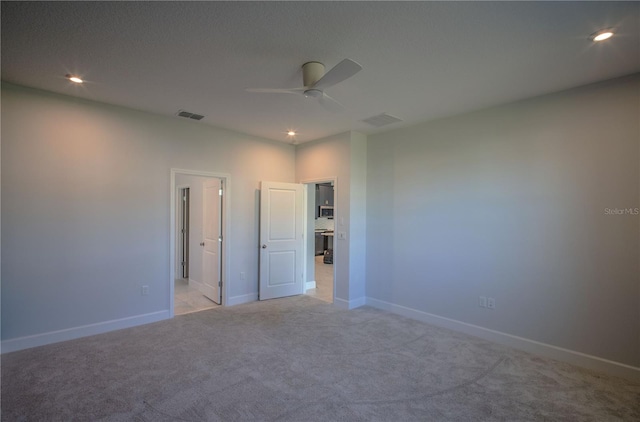 unfurnished bedroom featuring light carpet, visible vents, and recessed lighting