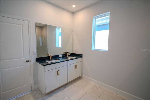 bathroom with a sink, baseboards, marble finish floor, a shower, and double vanity