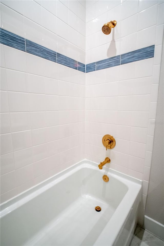 full bathroom with baseboards and bathing tub / shower combination