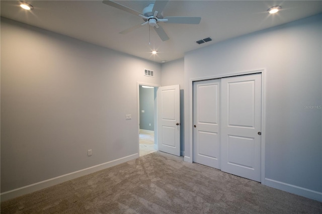 unfurnished bedroom featuring carpet, a closet, visible vents, and baseboards