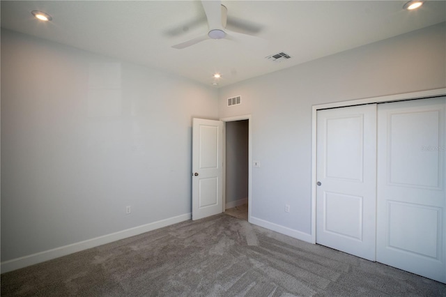 unfurnished bedroom with carpet, a closet, visible vents, and baseboards