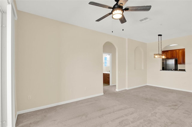 carpeted empty room featuring ceiling fan