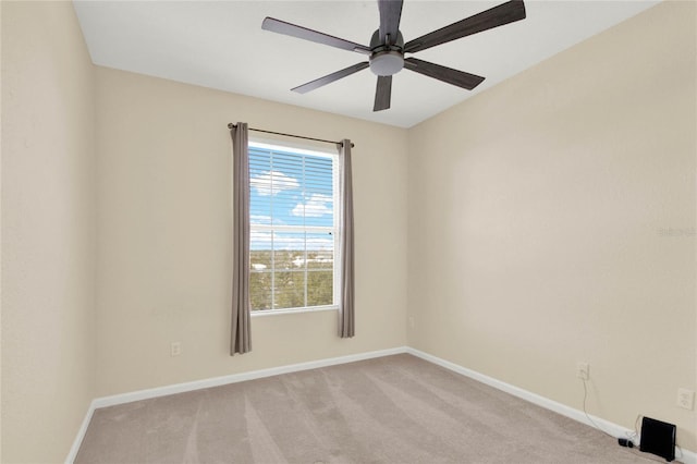 empty room with ceiling fan and light colored carpet