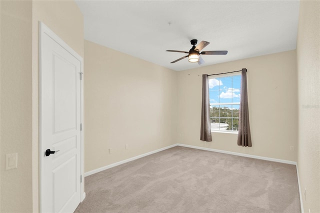 unfurnished room featuring light carpet and ceiling fan