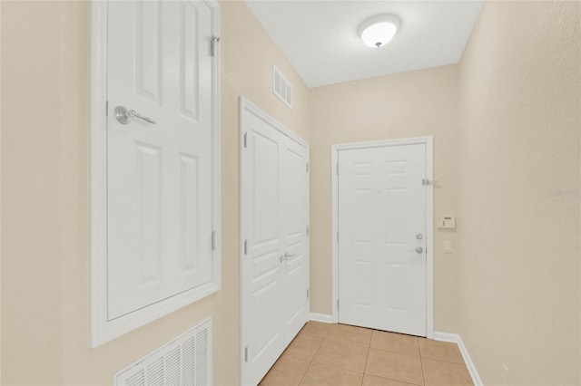 doorway to outside featuring light tile patterned floors